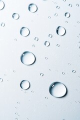 Poster - Close-up of water droplets on a smooth surface, creating a serene and refreshing atmosphere.