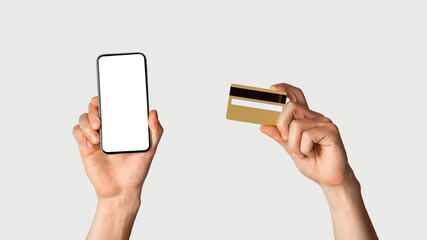 Poster - Online shopping concept. Unrecognizable man holdng credit card and smartphone with empty screen on white background, space for design. Panorama