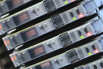 Poster - A row of servers with connectors on the side. The servers are stacked on top of each other