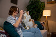 © fotodrobik - Cozy Moment A Woman Relaxes and Enjoys Quality Time with Her Cat in the Comfort of Home