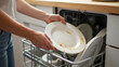 © Natalia - Close Photo Hands Putting Dirty Plate In Dishwasher
