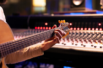 Aufkleber - Skilled singer performing on his electro acoustic guitar in control room, recording new sounds and mixing with audio console. Musician and technician composing a hit song for an album. Close up.