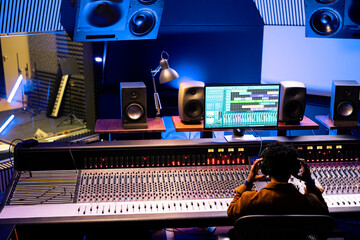 Poster - African american sound designer editing records in professional studio, working on mix and master tracks with control panel board desk. Skilled audio engineer producing new music, stereo gear.