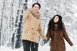 © Prostock-studio - Xmas Morning. Happy Man Walking With Girlfriend Holding Hands Pointing Finger Forward Showing Something In Winter Forest.