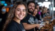 © Sam - Smiling woman of Hispanic descent with a group serving food at a bustling community event.