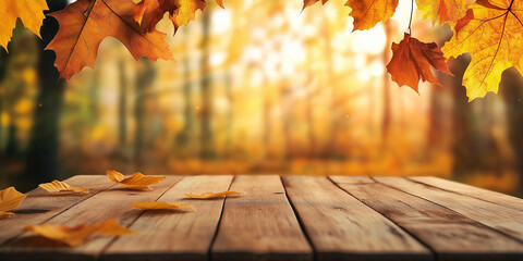 Poster - Empty wooden table with falling autumn leaves and blurred forest background