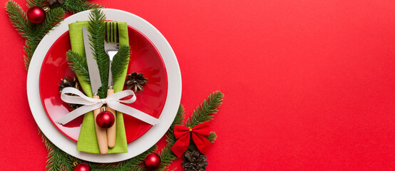 Sticker - Christmas table place setting with christmas decor and plates, kine, fork and spoon. Christmas holiday background. Top view with copy space