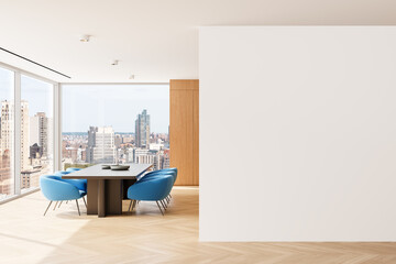 Wall Mural - Modern interior with blank white wall, wooden flooring, blue chairs, and a meeting table overlooking a cityscape through large glass windows. 3D Rendering