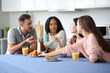 © Antonioguillem - Serious friends at breakfast talking in the kitchen