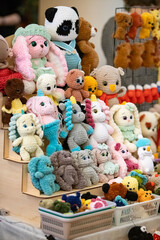 A display of stuffed animals, including teddy bears, pandas, and unicorns