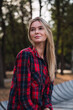 © Westend61 - Portrait of blond young woman wearing plaid shirt in autumn