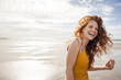 © Westend61 - Netherlands, Zeeland, portrait of laughing redheaded woman on the beach