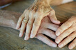 © Westend61 - Hands of senior couple consoling on table