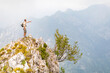 © Westend61 - Italy, Massa, man standing on top of a peak in the Alpi Apuane mountains