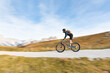 © Westend61 - Italy, Cortina d'Ampezzo, panning view of man cycling with mountain bike in the Dolomites mountains