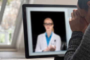 Poster - Man using computer to talk to specialist about his healthcare and recovery via online conference. Professional man engaged in solving issues during an online conversation, in a home office environment