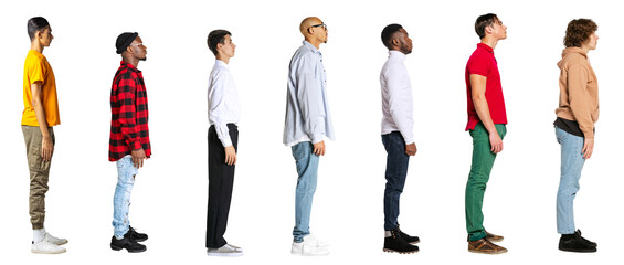 Wall Mural - Side view of young men in different casual style clothes standing in front of each isolated on transparent background. Banner. Concept of lifestyle, fashion, diversity, human rights