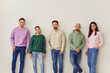 © Studio Romantic - Portrait of a group of young confident smiling friends students or colleagues in casual clothes standing together on a row isolated on a white background and looking positively at camera.