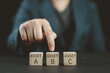 © Nirusmee - Investment asset allocation, Real estate investment. Money wealth management with funds. Diversification and risk management. Hand choosing on stacking coins with Assert A B C words on wooden blocks