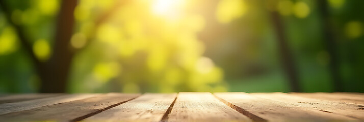 Poster - The selective focus is on a wood table top, while the surrounding tree foliage is blurred in a morning sunbeam._00001_