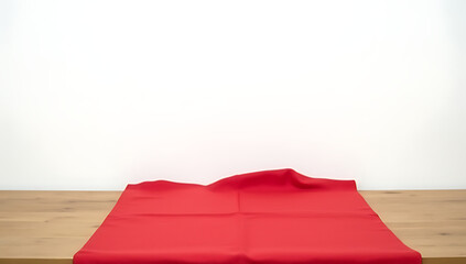 Poster - A piece of red cloth lies draped over a wooden table in front of a plain white background on the wall._00002_