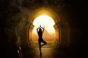 Wall Mural - Young woman in meditation posture inside Buddhist temple