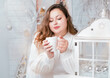 © dymytrov - beautiful sexy chubby girl on a light cristmas background in a white dress . Model plus size.