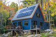 © Dmitriy - A modern house with solar panels on the roof, showcasing sustainable energy technology.