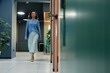 © Seventyfour - Full length shot of young curly woman in elegant blue clothes walking confidently along office rooms in corridor of modern coworking space, copy space