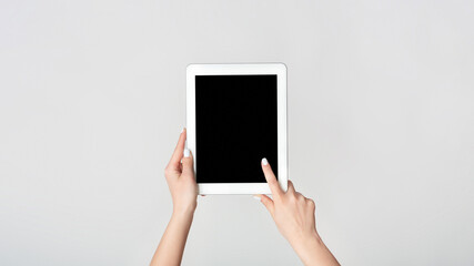 Poster - Female hand touching blank screen of tablet computer on white background, mockup for your design. Panorama