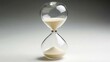 © coroze - Close-Up View of a Classic Hourglass with Flowing Sand Against a Soft Gradient Background