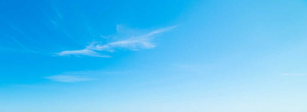 Small white clouds in the blue sky