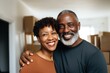 © Baba Images - Portrait of a smiling middle aged couple in modern home
