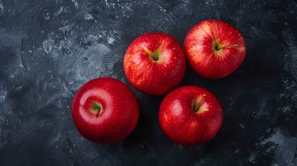 Canvas Print - Vivid red apples on a textured dark surface