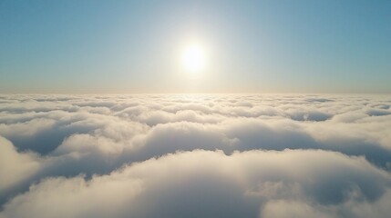 Canvas Print - Aerial view of fluffy clouds and bright sun above.