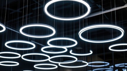 Poster - Modern lighting installation featuring circular LED rings suspended from the ceiling