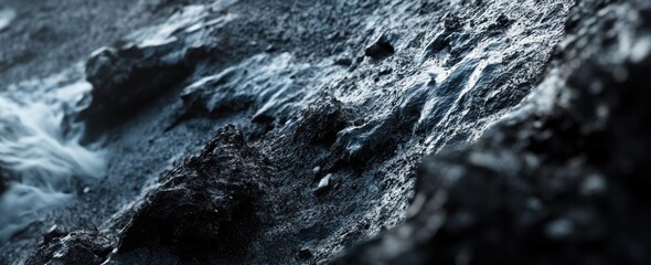 Poster - Rough, dark stone surface texture with icy, smooth sections.