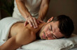 © Krystyna - A man receives a relaxing back and neck massage in a spa salon.
