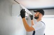 © Serhii - Repairman fix air conditioning systems, Male technicians service for repair and maintenance of air conditioners, Air conditioning technicians install new air conditioners in homes