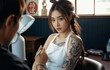 © RooftopStudioBangkok - woman with intricate tattoos on her arm sits in tattoo studio, looking contemplative as artist works on her design. room is softly lit, creating calm atmosphere