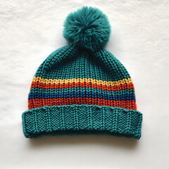 Wall Mural - Vibrant Teal Knitted Beanie with Playful Stripes