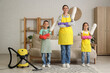 © Pixel-Shot - Mother and her children with cleaning supplies at home