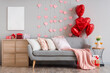 © Pixel-Shot - Interior of festive living room with grey sofa, hearts and heart-shaped balloons. Valentine's Day celebration