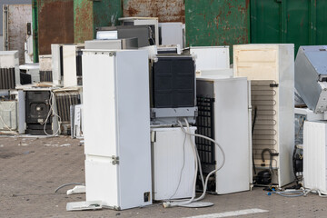discarded refrigerators and washing machines at junkyard