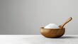 © suteeda - Tub of organic coconut oil with a wooden spoon, arranged on a white background for a clean, multipurpose health product .