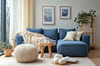 © Poramet - Two knitted poufs near dark blue corner sofa. Scandinavian home interior