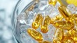 © Artyom - Yellow gel capsules on clear ice in glass bowl