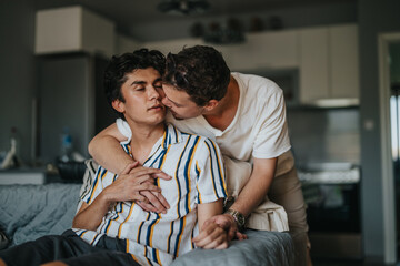 Wall Mural - A loving gay couple embraces in a warm and intimate moment at home, expressing affection and closeness. The cozy living space adds to the overall sense of comfort and togetherness.