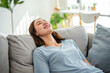 © Kawee - Asian beautiful girl lying down on comfort sofa in living room at home.