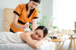 © Kawee - Asian young woman getting thai hot compress massage with herbal bags.